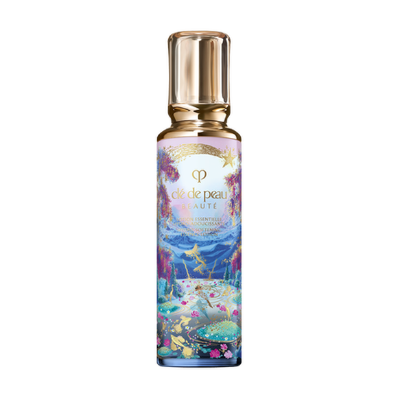 Photo of the 26 AW Holiday Collection limited-edition HYDRO-SOFTENING ESSENCE LOTION. The tall glass bottle features a scenic illustration of a lake with gold-colored fish and pink flowers, decorated with a gold shooting star and a clear gold cap.